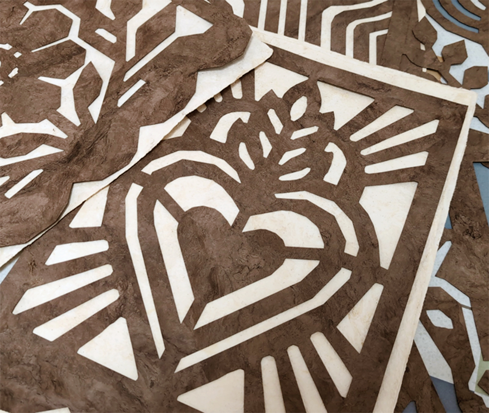 Café Calado cut-outs in brown Café amate laid over natural Crème amate