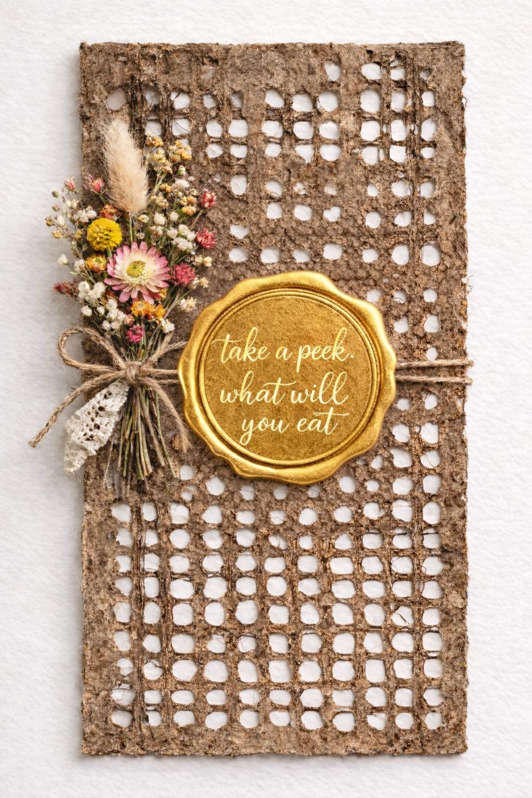 Café amate paper card tied with twine, a dried-flower posy and a gold wax seal