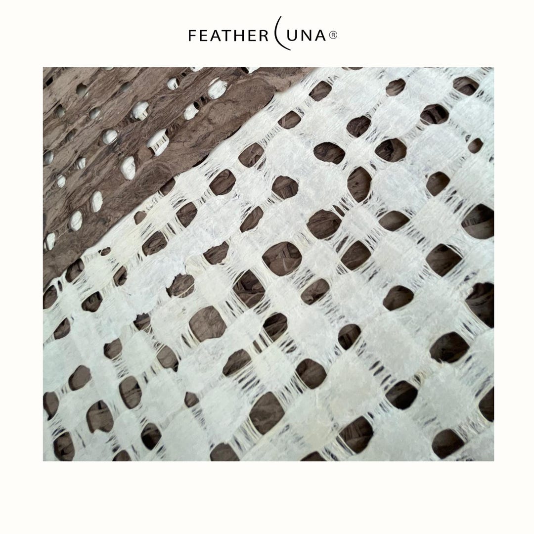 A sheet of Crème amate paper laid over Café, close up of the open grid