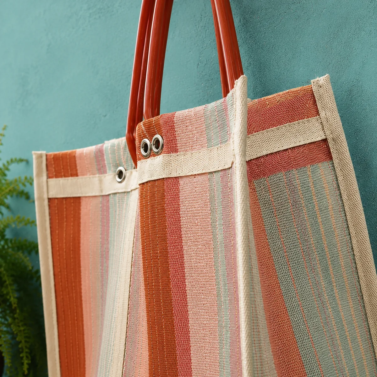 The workshop on Calle Roldán — mesh bags bundled by color on a long wooden table