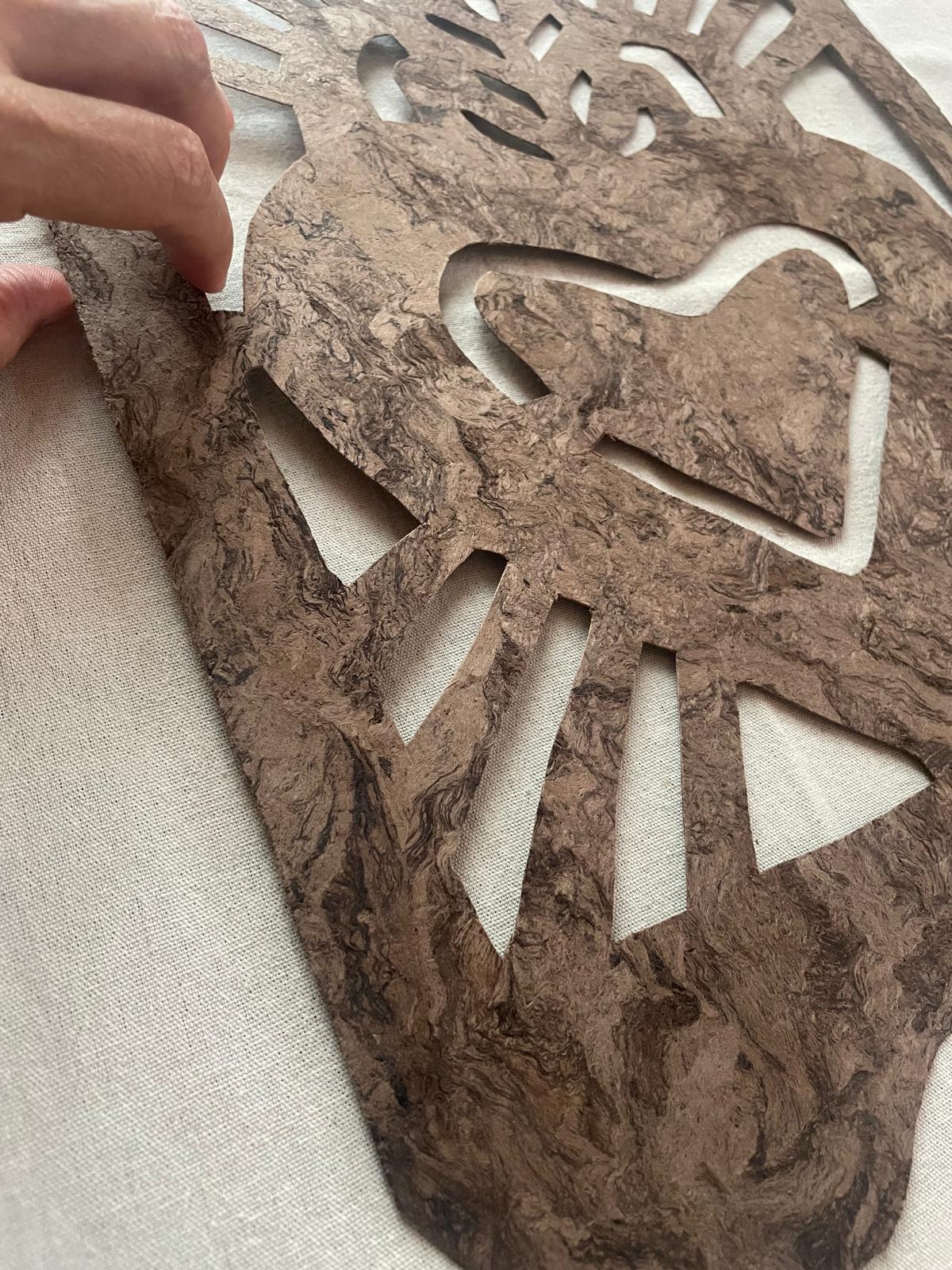Close-up of the cut work and bark fibre texture on the Corazón Sagrado piece