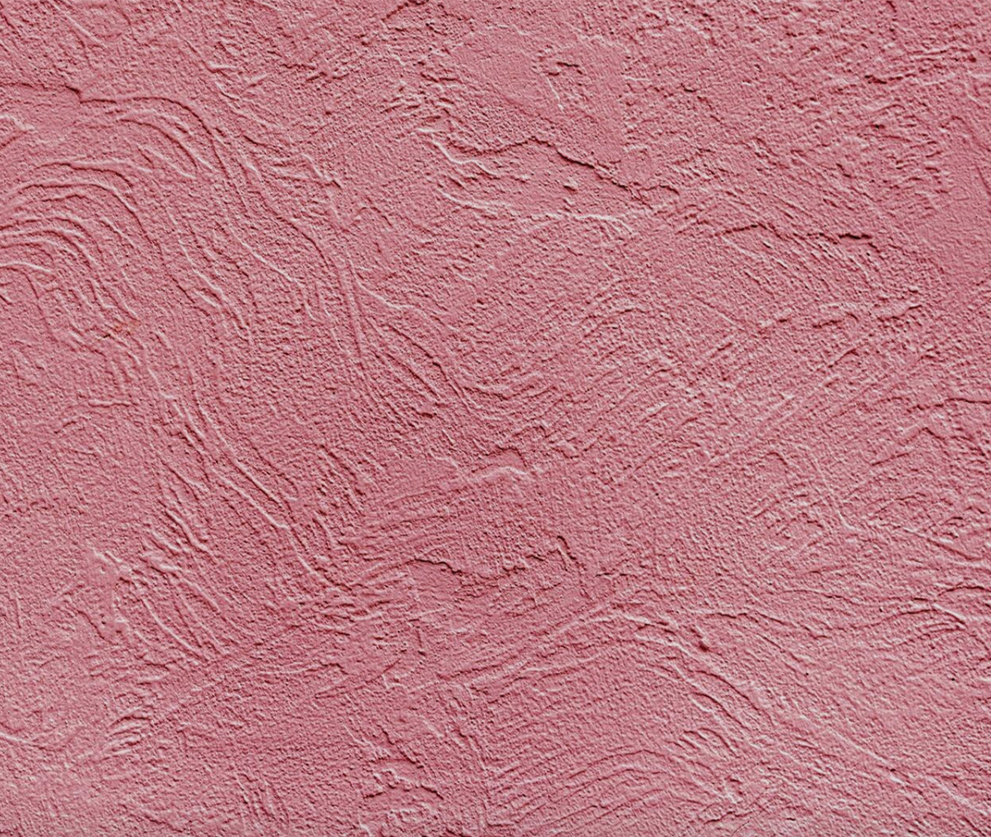 A pink plaster wall, the kind of colour that shows through the cutwork