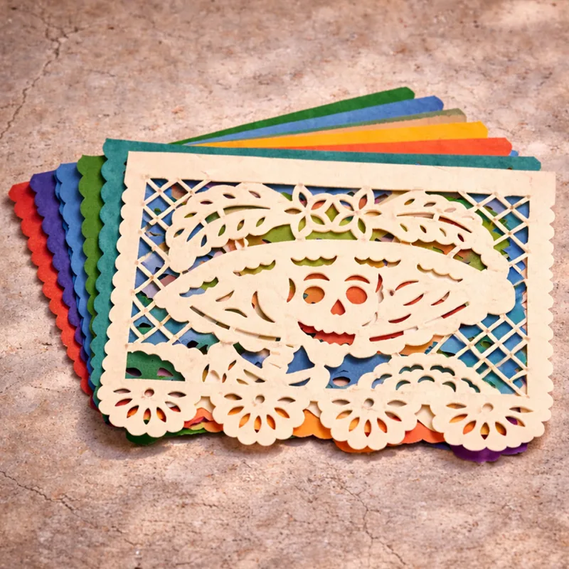 Colorful stacked papel picado sheets with Catrina skull design